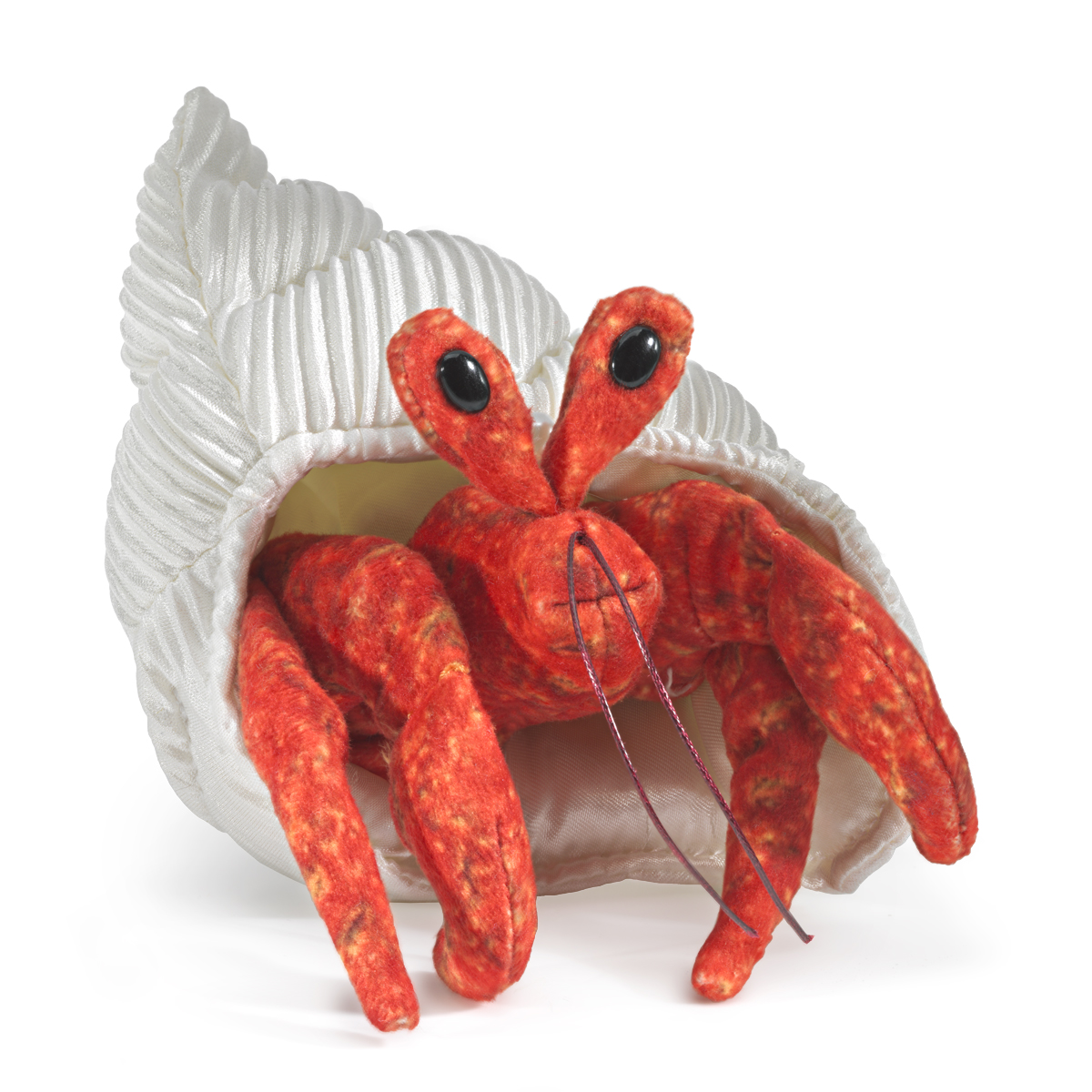 Folkmanis mini hermit crab finger puppet in red-orange peeks out of a white fabric shell, black button eyes, front view