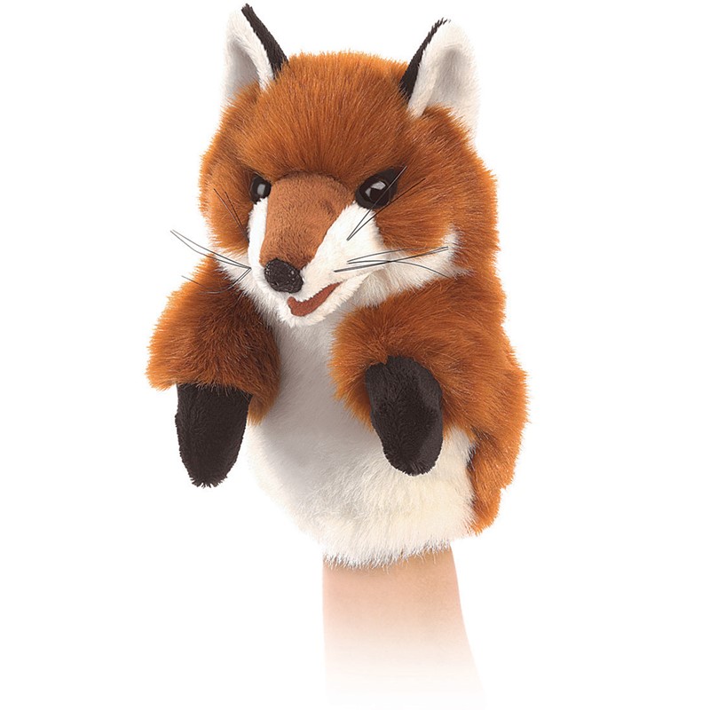 Folkmanis small fox hand puppet with rust-red fur, white chest and black paws, shown worn on a hand