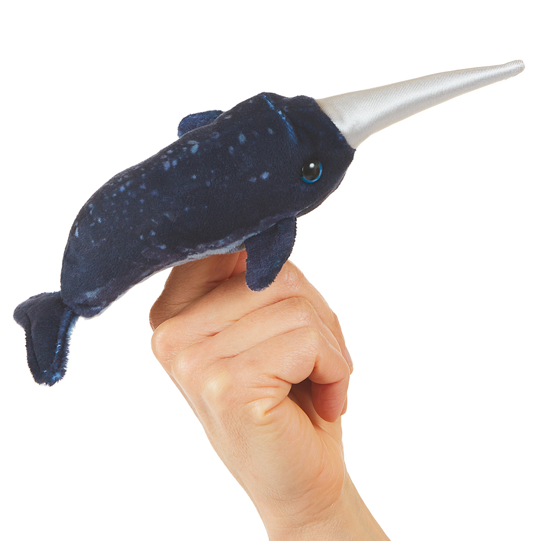 Folkmanis mini narwhal finger puppet in dark blue with a silver horn, worn on an index finger, side view