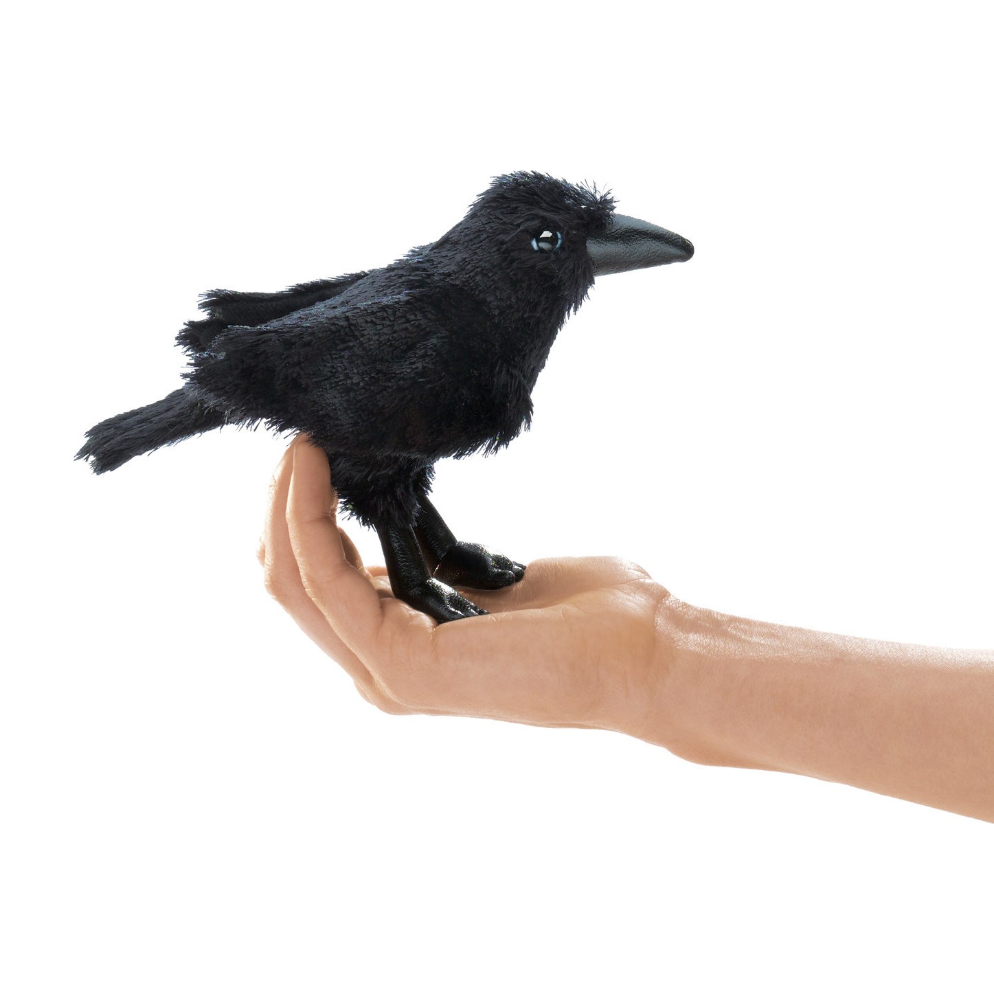 Folkmanis mini raven finger puppet in black sitting on a palm, side view with detailed claws