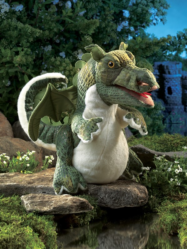 Folkmanis baby dragon hand puppet in green with a white belly, open mouth and wings, in front of a castle backdrop