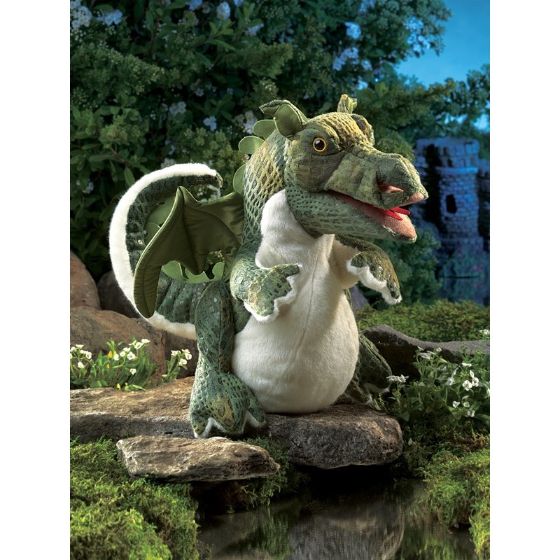 Folkmanis baby dragon hand puppet in green with a white belly, open mouth and wings, in front of a castle backdrop