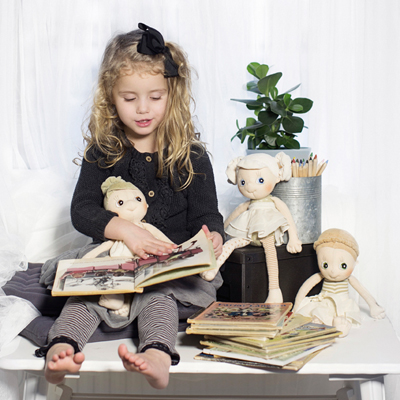 Child reading to the Rubens EcoBuds dolls from old picture books