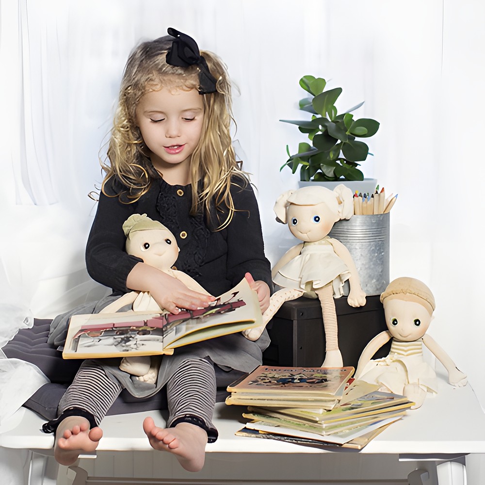 Child reading to the Rubens EcoBuds dolls from old picture books
