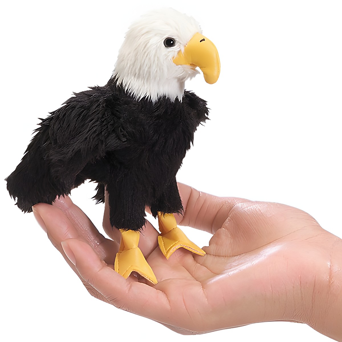 Folkmanis mini finger puppet bald eagle with black plumage and yellow beak sitting on an open palm