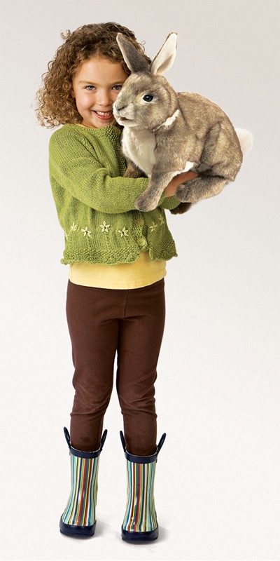 Girl holding the Folkmanis Cottontail Rabbit hand puppet in grey-brown plush, full-body view