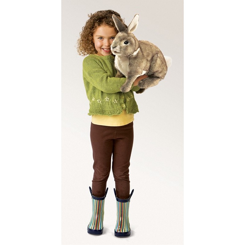 Girl holding the Folkmanis Cottontail Rabbit hand puppet in grey-brown plush, full-body view