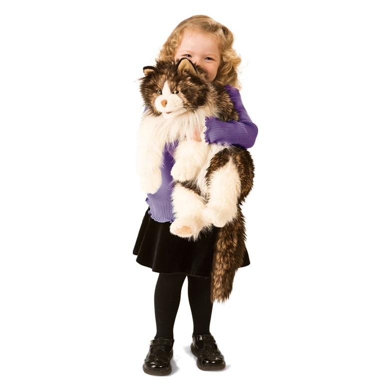 Small girl holding a large Folkmanis hand puppet fluffy cat with brown and white fur in her arms
