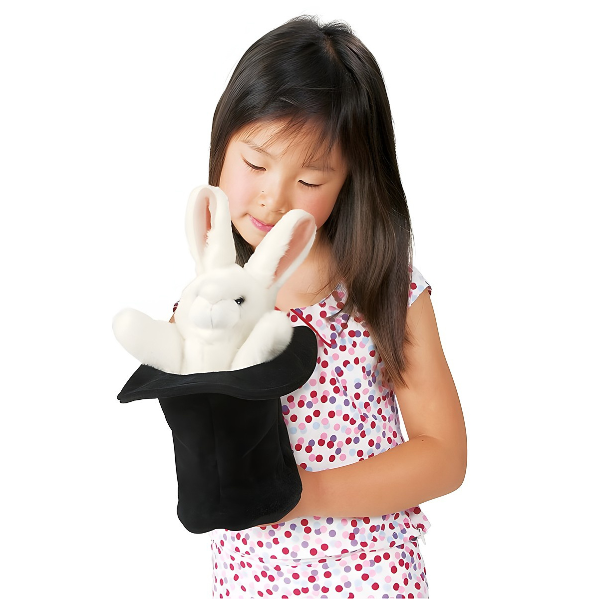 Girl holding a Folkmanis hand puppet of a white rabbit in a black top hat, smiling as she looks down at it