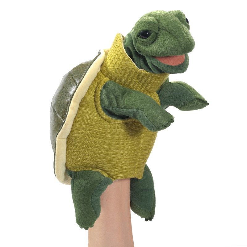 Folkmanis turtleneck turtle hand puppet worn on a hand, shown from the side, with a yellow turtleneck sweater