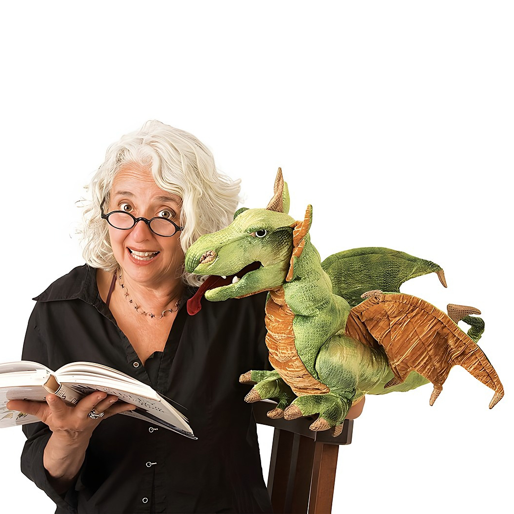 Folkmanis hand puppet wyvern dragon in green with wings, sitting on the shoulder of a woman holding a book