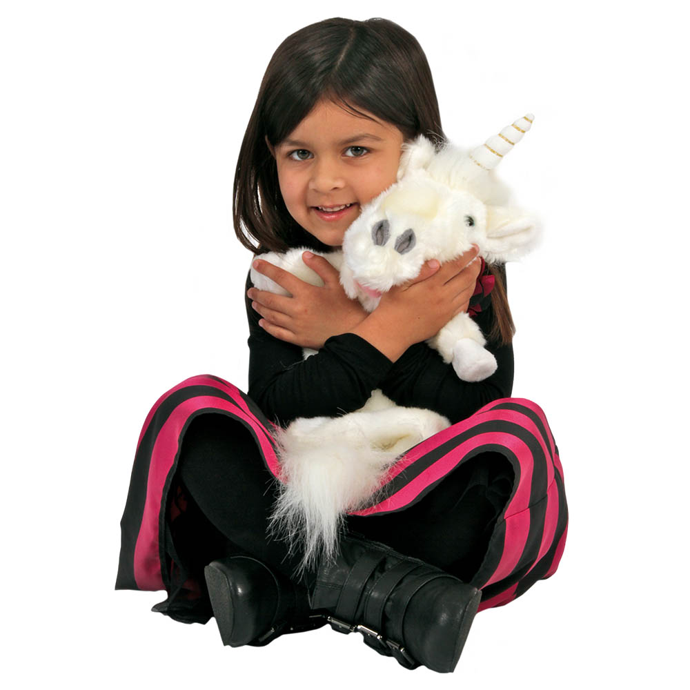 Girl hugging the The Puppet Company unicorn hand puppet, usage example