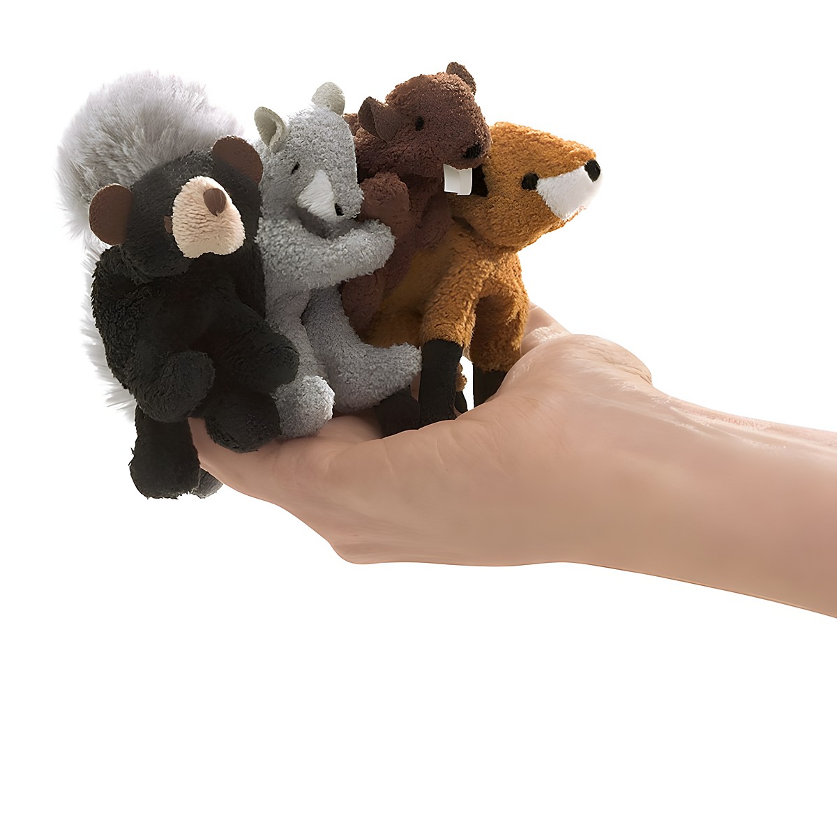 Four Folkmanis woodland animal finger puppets — skunk, squirrel, beaver and fox — held on one hand to show size comparison