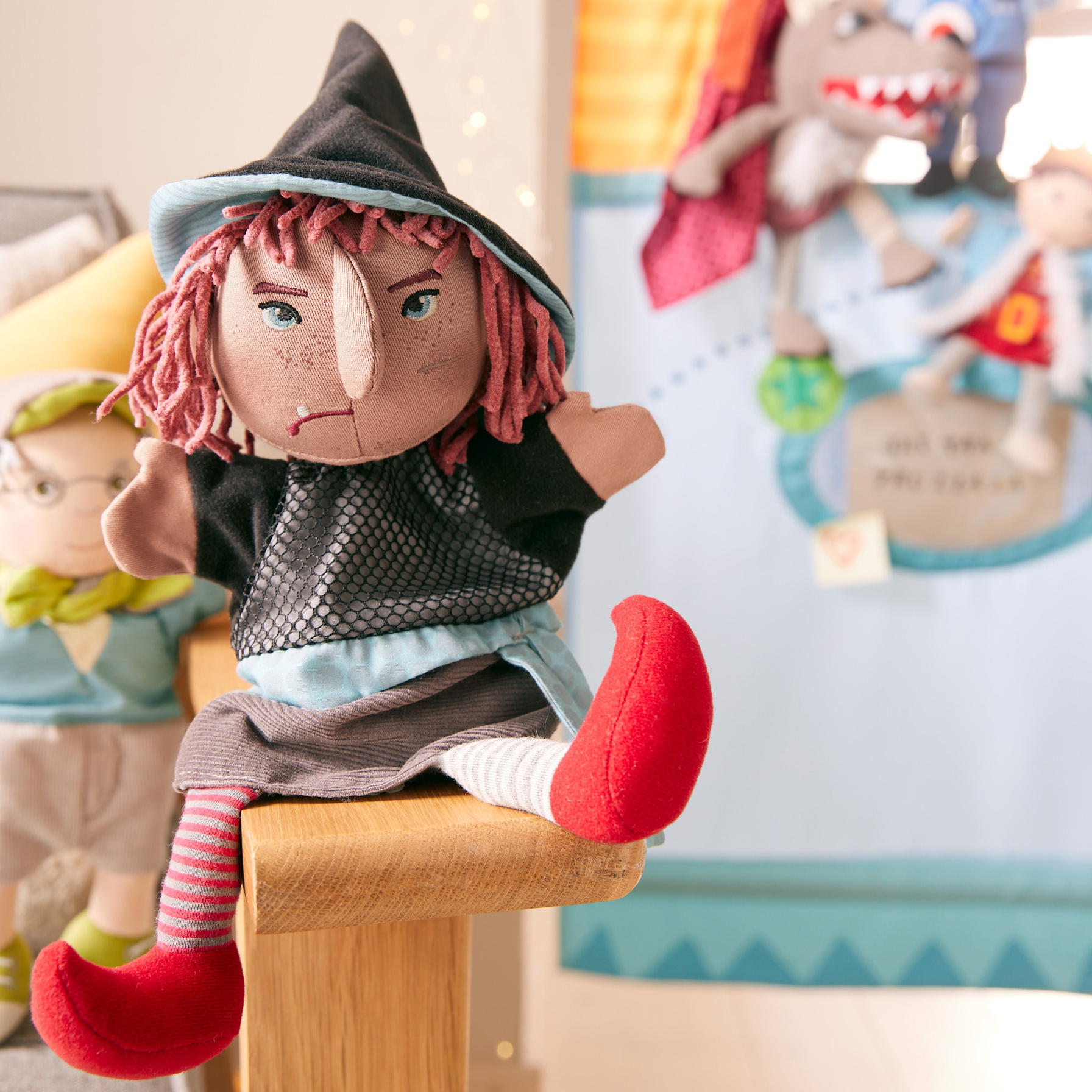 HABA baby hand puppet witch Hella, lifestyle photo in front of a puppet theatre