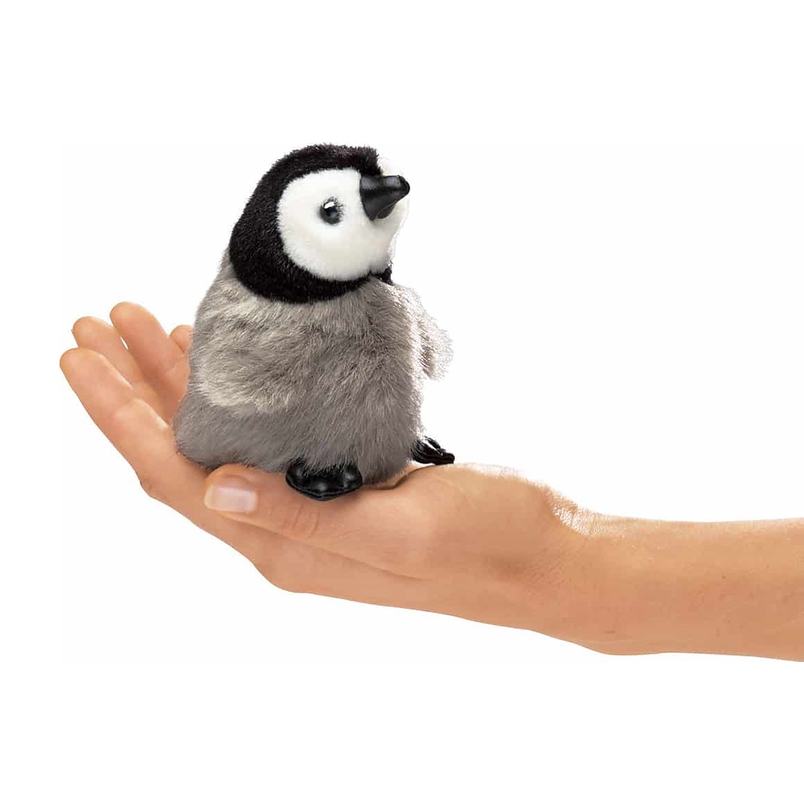 Folkmanis mini baby emperor penguin finger puppet with grey plush belly and black head, sitting on a palm