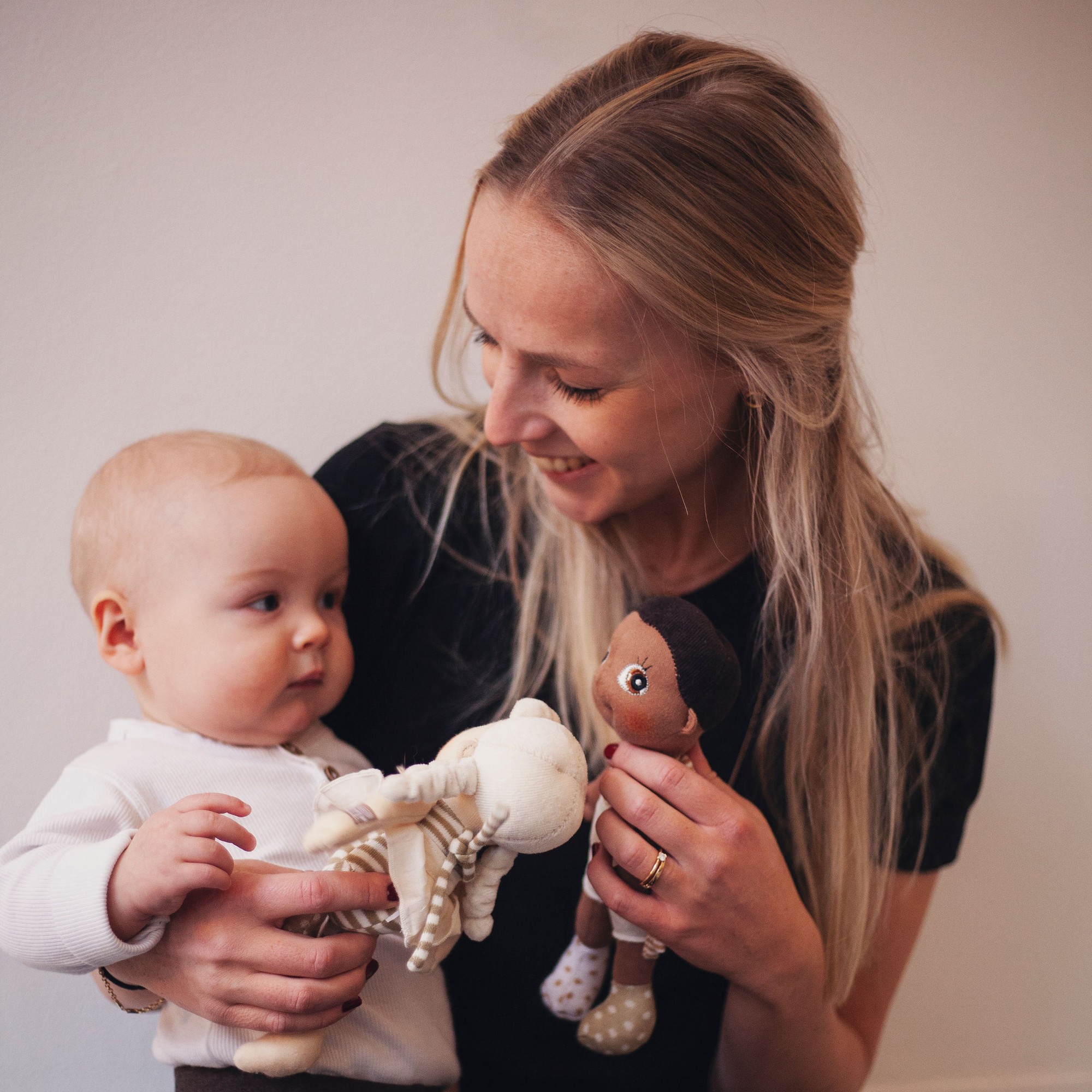 Woman and baby playing with the Rubens EcoBuds mini dolls