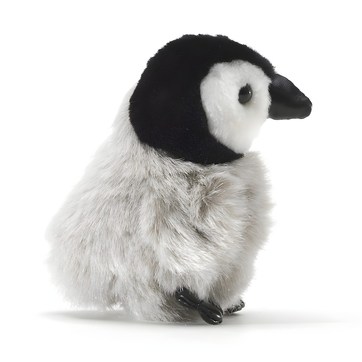 Folkmanis mini baby emperor penguin finger puppet in side view, fluffy grey plumage, black head with white face