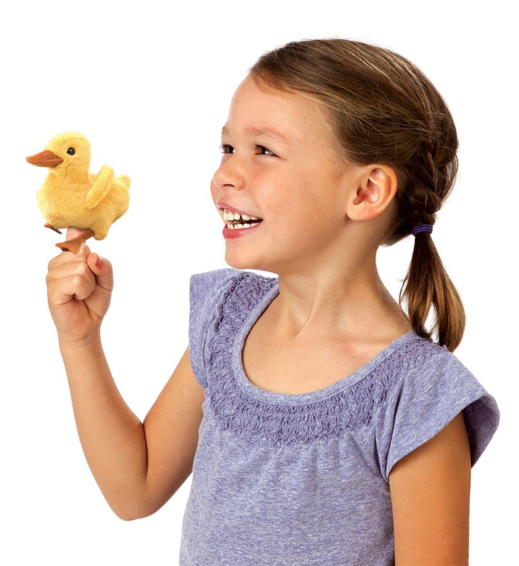 Girl holding a yellow Folkmanis mini duckling finger puppet on her index finger and laughing