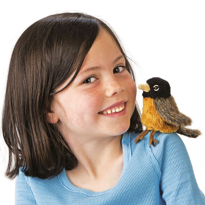 Girl with the Folkmanis mini robin finger puppet sitting on her shoulder