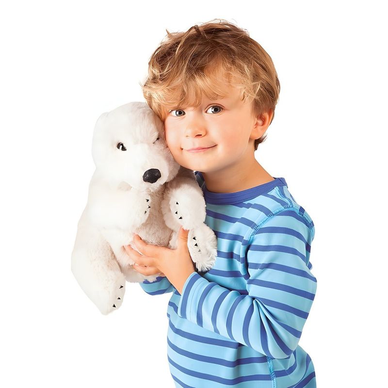 Boy cuddling the Folkmanis sitting polar bear hand puppet against his cheek