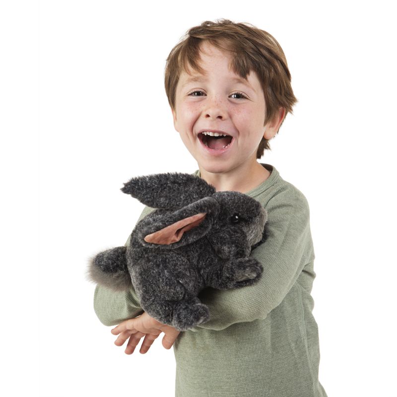 Laughing boy holding the Folkmanis grey bunny hand puppet in both arms